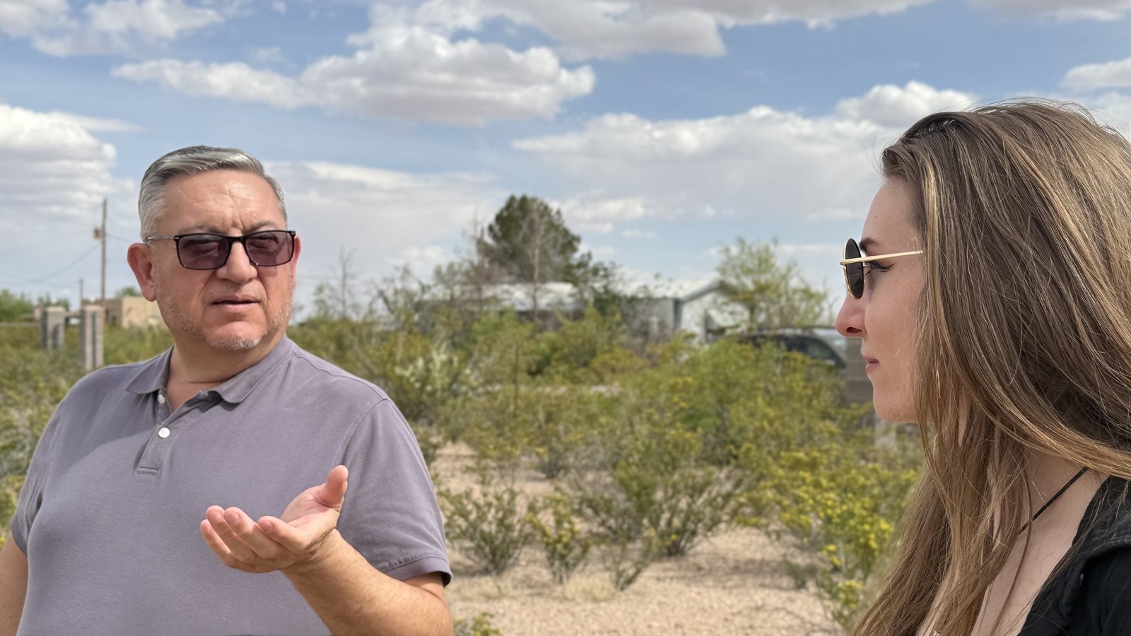 Two people talking on the shrine grounds during a site visit
